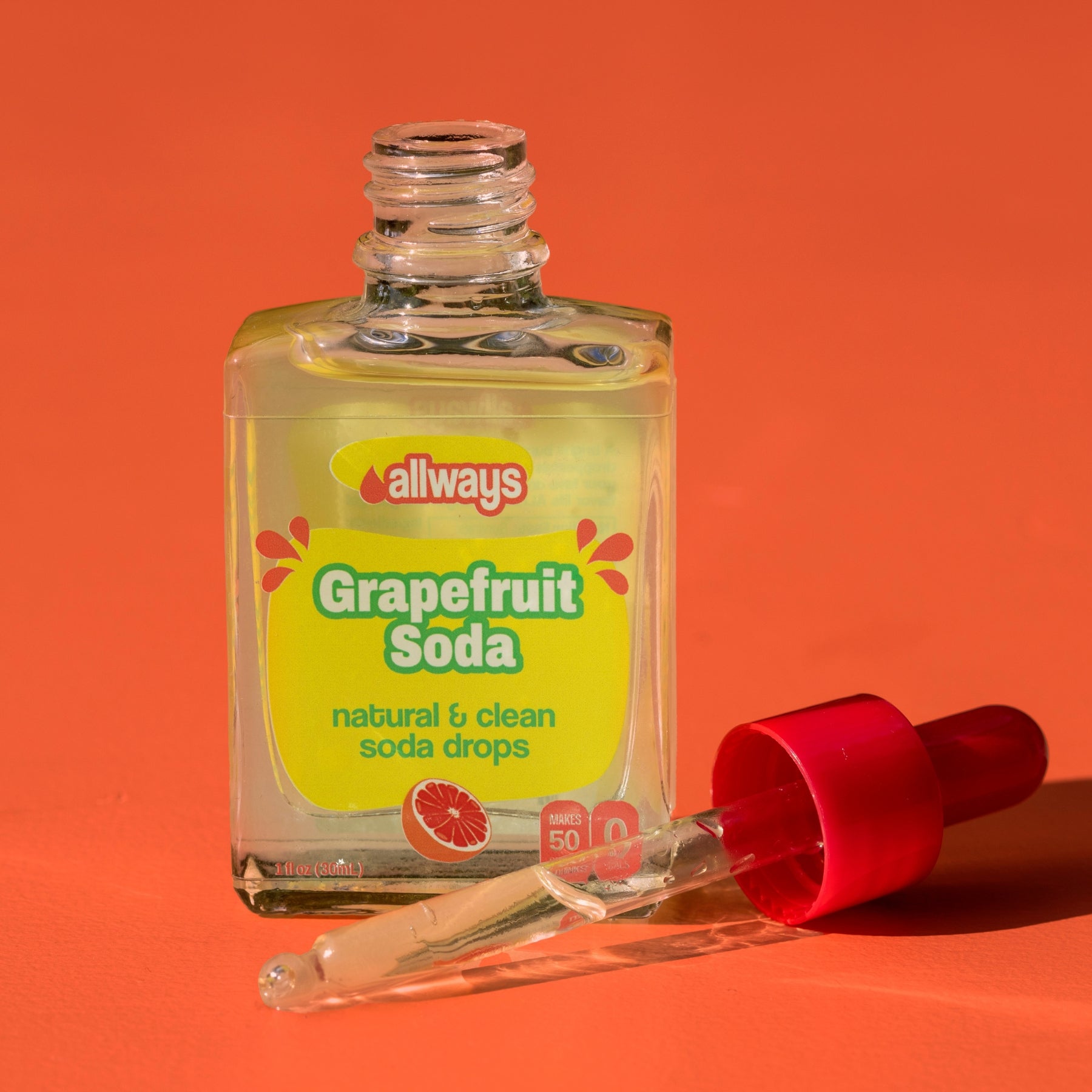 Bottle of 'allways Grapefruit Soda' with a red dropper on an orange background