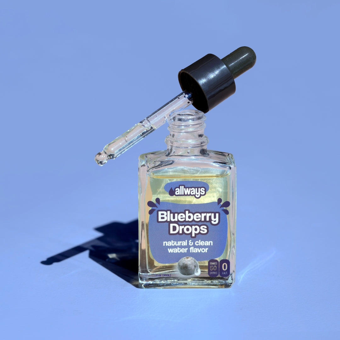 Allways blueberry drops in a glass bottle with dropper balancing on top in front of a blue background