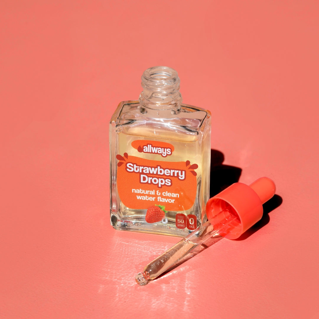 Allways Strawberry Drops in a glass bottle with glass dropper laying next to it in front of a red background