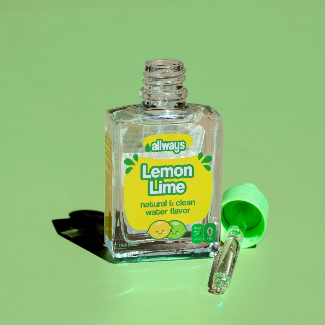 Allways Lemon Lime Drops with dropper laying next to glass bottle in front of a green background