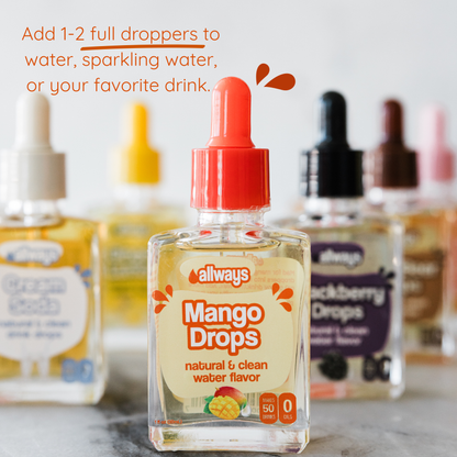 Bottle of Mango Drops with dropper on a blurred background of other similar bottles.