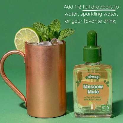 Moscow Mule cocktail with lime and mint next to a bottle of Allways Moscow Mule mocktail drops on a green background.
