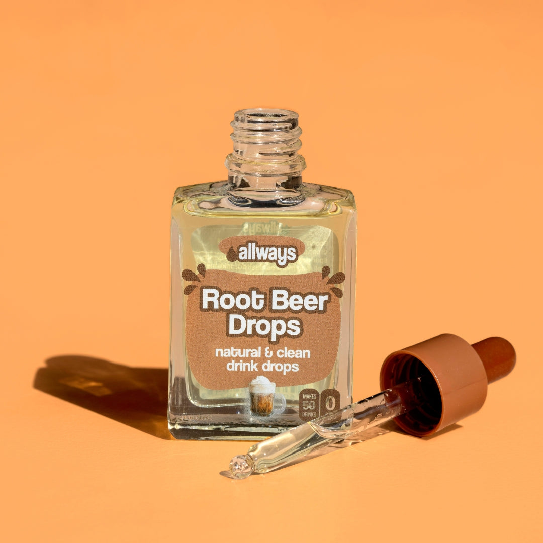 Allways Root Beer Drops with dropper laying next to glass bottle in front of an orange background