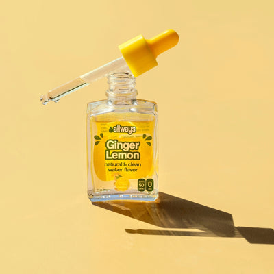 allways ginger lemon drops in a glass bottle with dropper balancing on top in front of a yellow background