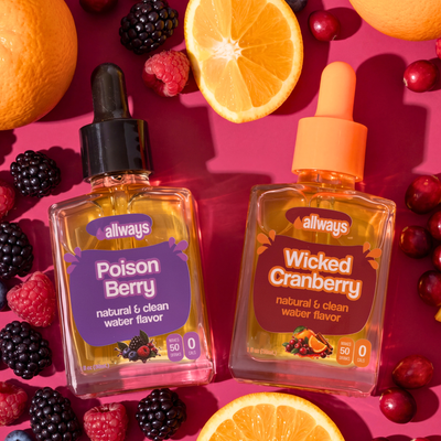 Two bottles of Allways Drops, Poison Berry and Wicked Cranberry, arranged on a hot pink background with fresh berries, oranges, and raspberries.